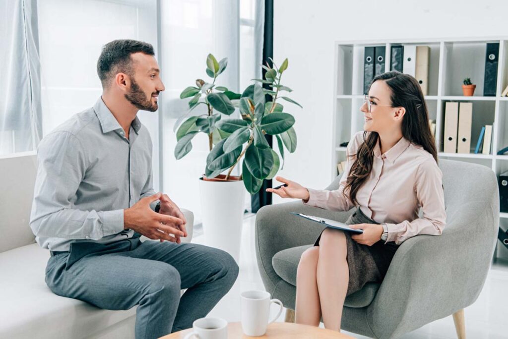 a doctor discusses delaware mental health facilities and lotus mental health programs with a man interested in dual diagnosis treatment