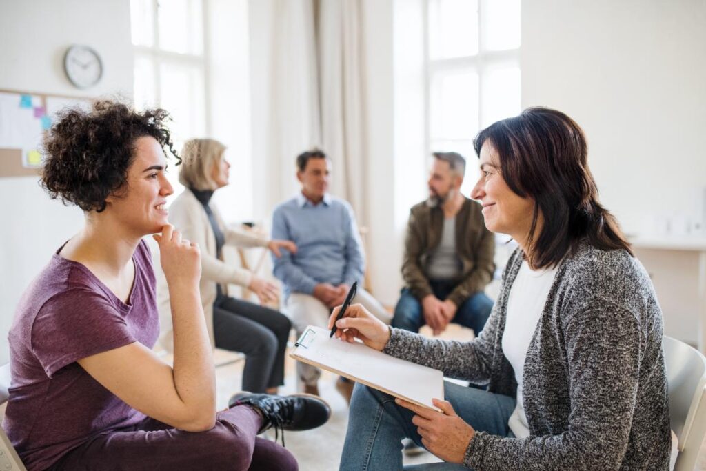 a woman engages in group therapy in lotus residential services
