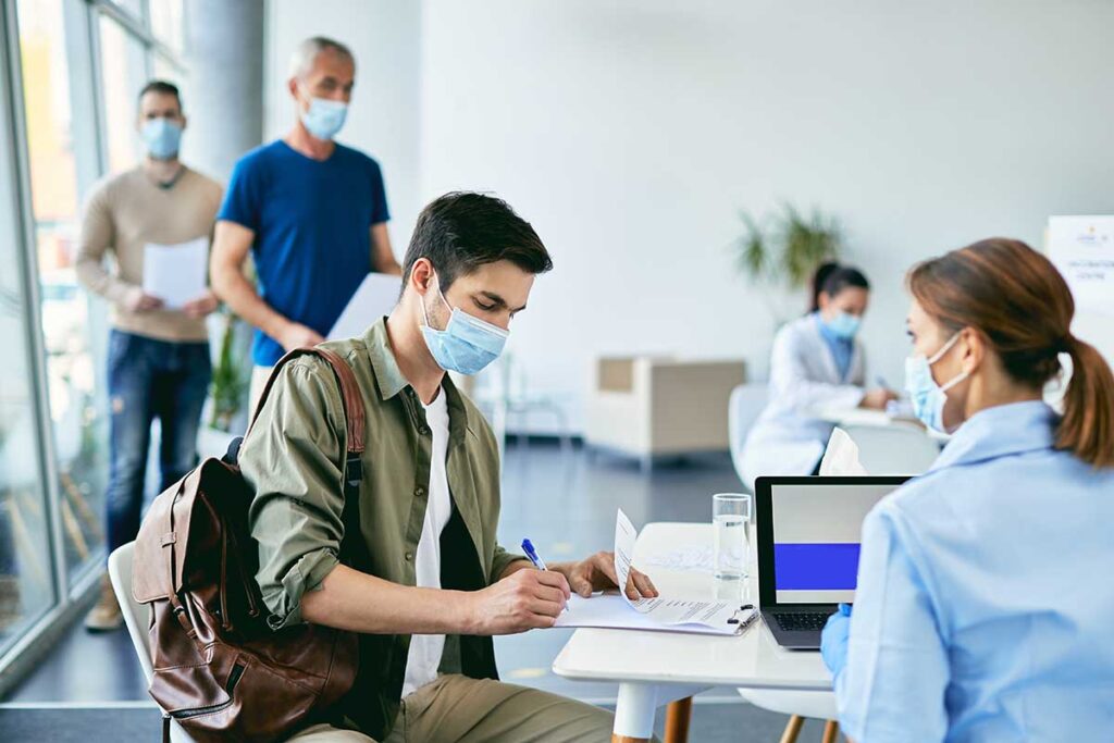 people in masks at a clinic