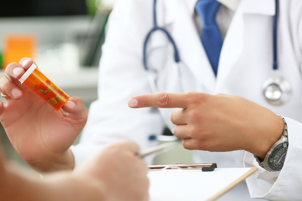 doctor pointing at pills