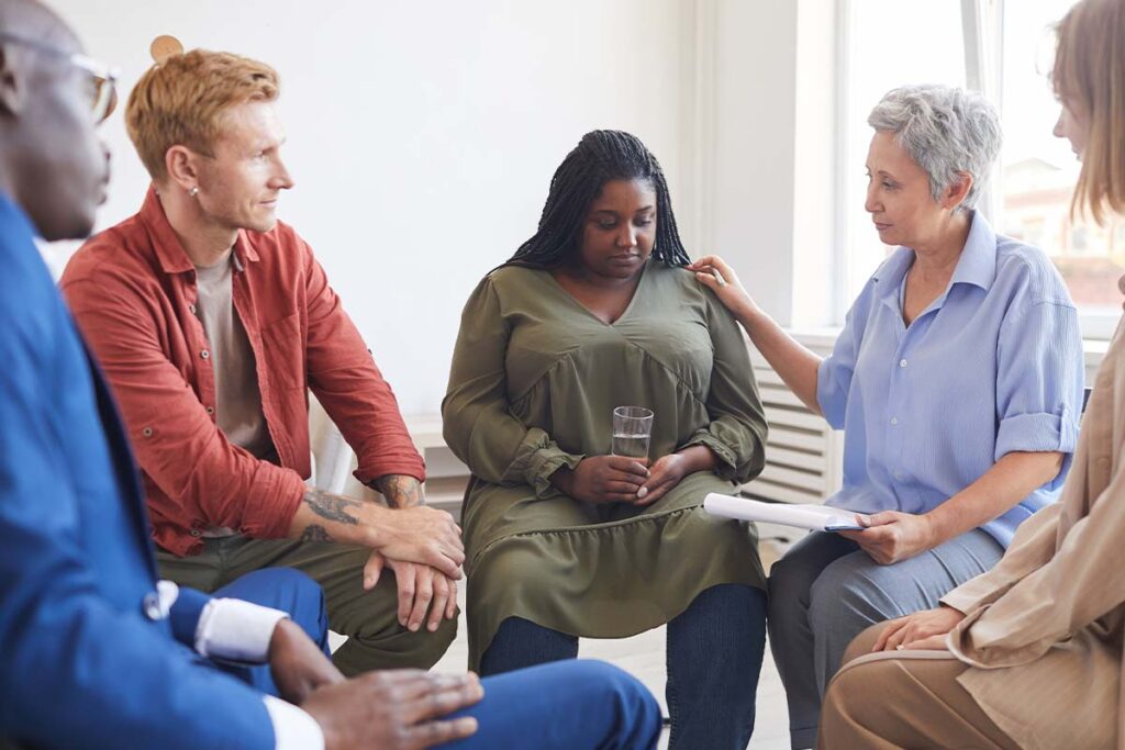 Group therapy participants in an extended residential treatment center