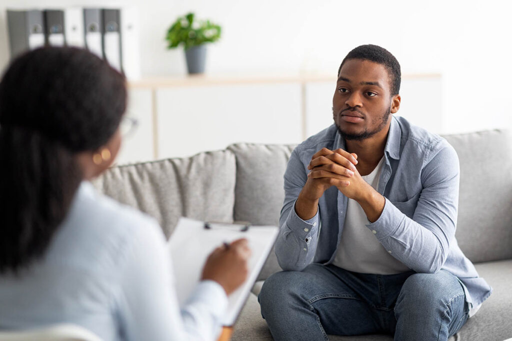 Man and therapist discuss crisis stabilization treatment